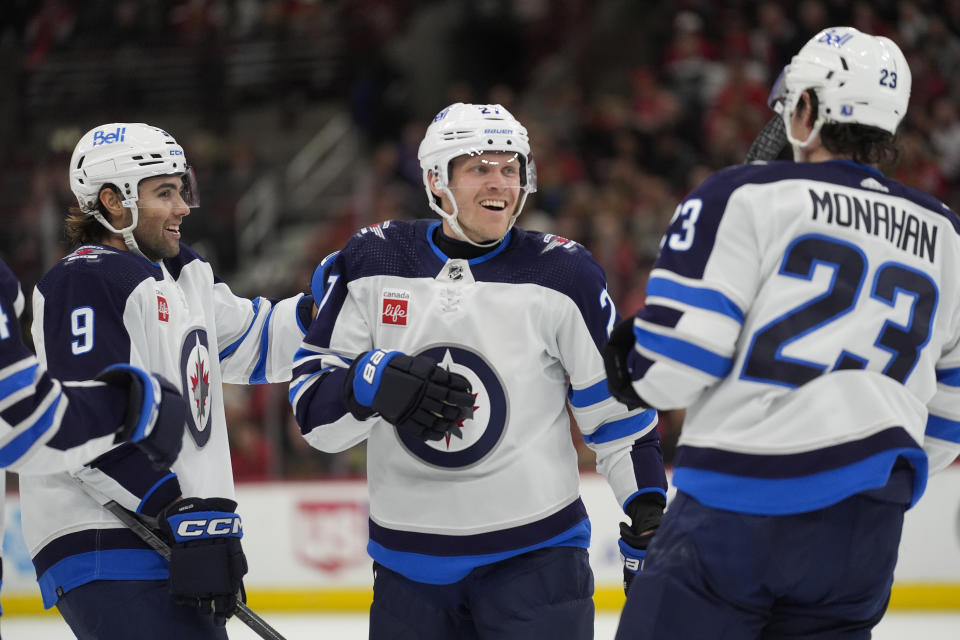 Winnipeg Jets left wing Alex Iafallo, left wing Nikolaj Ehlers and center Sean Monahan, from left, celebrate Ehlers' goal against the Chicago Blackhawks during the first period of an NHL hockey game Friday, Feb. 23, 2024, in Chicago. (AP Photo/Erin Hooley)