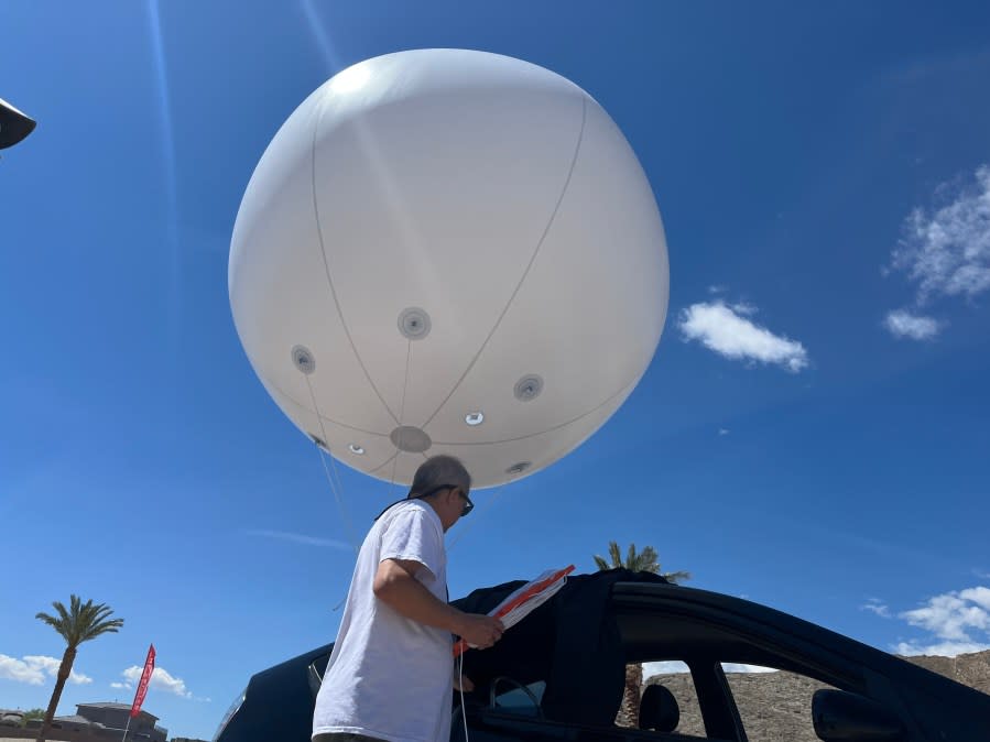 The seven-foot, white, helium balloon assembled by Jon Dorsey, owner of Mr. Balloon, was purchased by an unnamed Lone Mountain resident to illustrate the height of 216 feet, the current maximum height of a proposed Church of Jesus Christ of Latter-Day Saints temple. (KLAS)