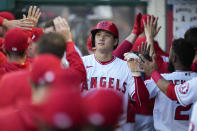 Los Angeles Angels' Shohei Ohtani (17) celebrates in the dugout after scoring off of a home run hit by Max Stassi during the first inning of a baseball game Tuesday, July 6, 2021, in Anaheim, Calif. (AP Photo/Ashley Landis)