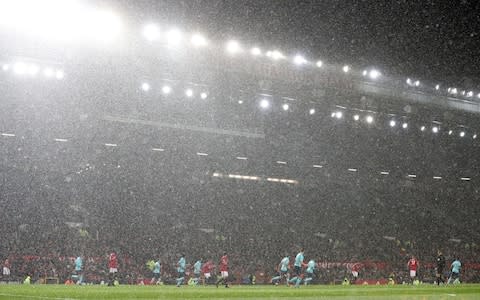 it's wet at old trafford - Credit: PA