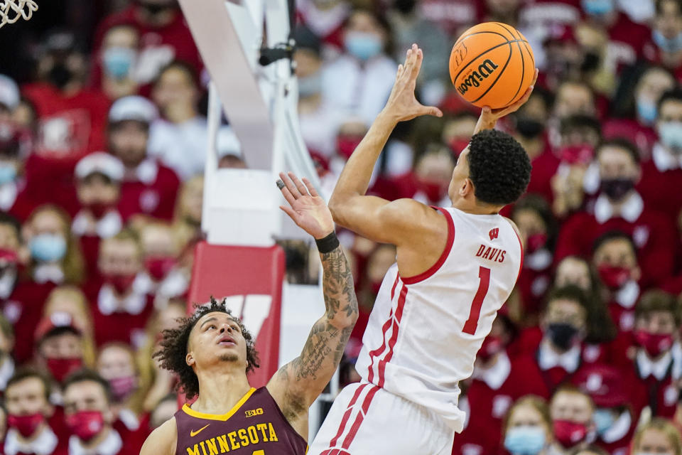 Wisconsin's Johnny Davis (1) shoots against Minnesota's Sean Sutherlin (24) during the first half of an NCAA college basketball game Sunday, Jan. 30, 2022, in Madison, Wis. (AP Photo/Andy Manis)