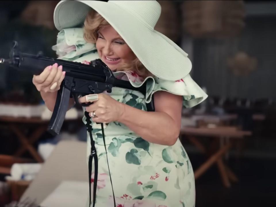 Jennifer Coolidge with a machine gun in "Shotgun Wedding."