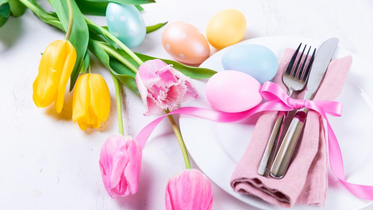 easter table setting with spring flowers and easter eggs