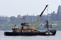 <p>Officials remove a plane from the Hudson River a day after it crashed, Saturday, May 28, 2016, in North Bergen, N.J. The World War II vintage P-47 Thunderbolt aircraft crashed into the river Friday, May 27 killing its pilot. (AP Photo/Julio Cortez) </p>