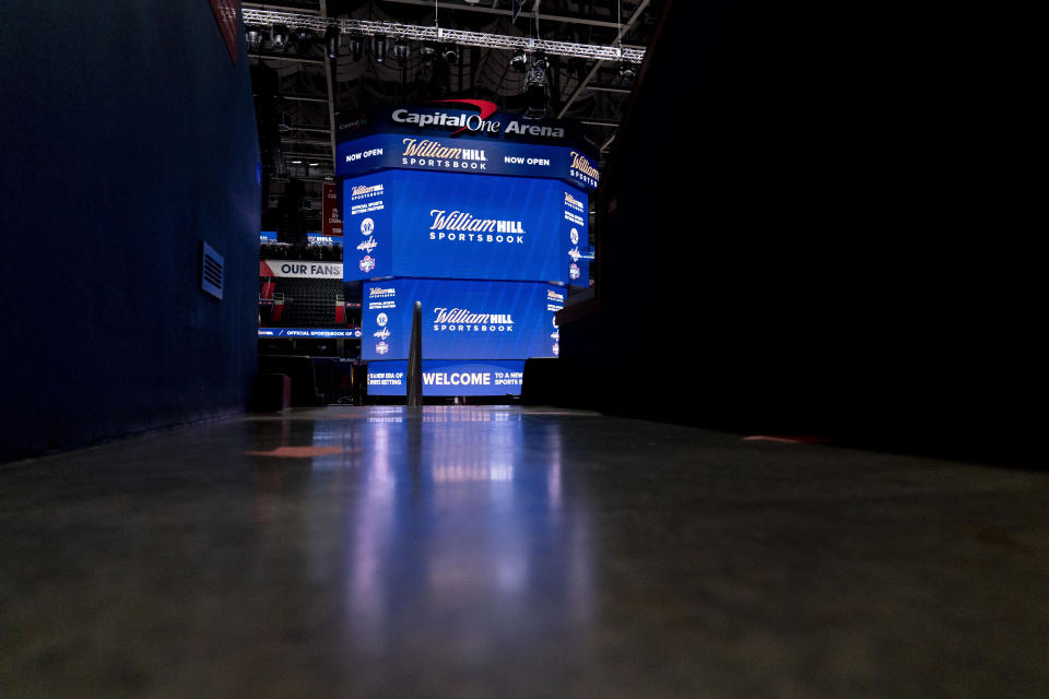 Screens display the William Hill Sportsbook logo at Monumental Sports & Entertainment's Capital One Arena in Washington, Wednesday, May 26, 2021. The first full-service sportsbook at a major four North American pro sports venue in the United States opens its doors. (AP Photo/Andrew Harnik)