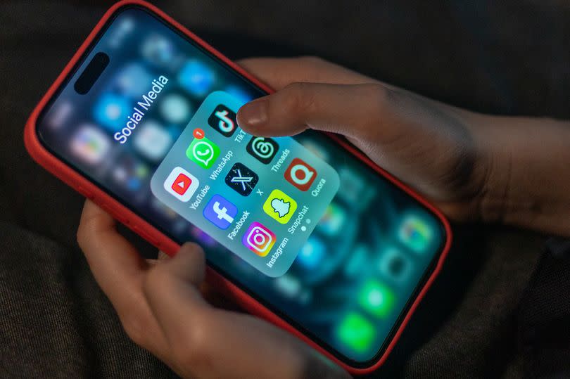 BATH, UNITED KINGDOM - DECEMBER 19: A 12-year-old boy looks at an iPhone screen showing various social media apps including TikTok, Facebook and X, on December 19, 2023 in Bath, England. The amount of time children spend on screens each day rocketed during the Covid pandemic by more than 50 per cent, the equivalent of an extra hour and twenty minutes. Researchers say that unmoderated screen time can have long-lasting effects on a child's mental and physical health. Recently TikTok announced that every account belonging to a user below age 18 have a 60-minute daily screen time limit automatically set. (Photo by Matt Cardy/Getty Images)