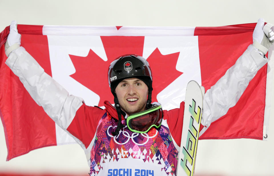 Canada's Alex Bilodeau celebrates after winning the gold medal in the men's moguls final at the 2014 Winter Olympics, Monday, Feb. 10, 2014, in Krasnaya Polyana, Russia. (AP Photo/Andy Wong)