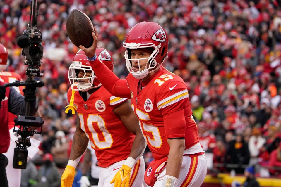 Kansas City Chiefs quarterback Patrick Mahomes (15) celebrates after throwing an 8-yard touchdown pass to running back Isiah Pacheco (10) during the first half of an NFL football game Sunday, Dec. 31, 2023, in Kansas City, Mo.