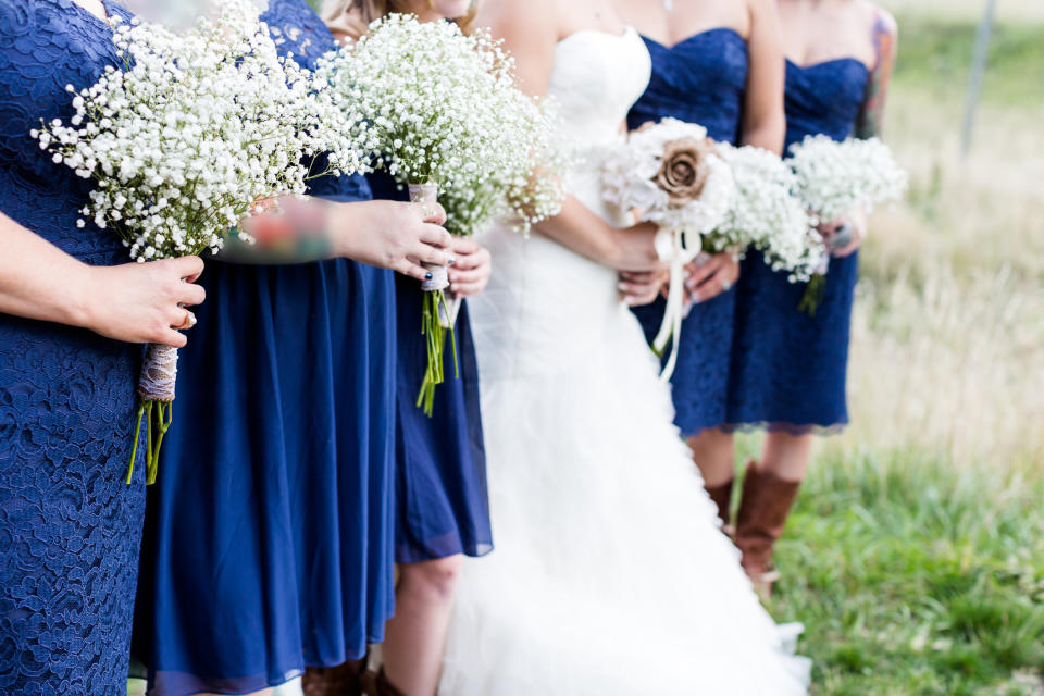 Is it reasonable to tell off your bridesmaid for holding her bump in the wedding pictures? [Photo: Getty]