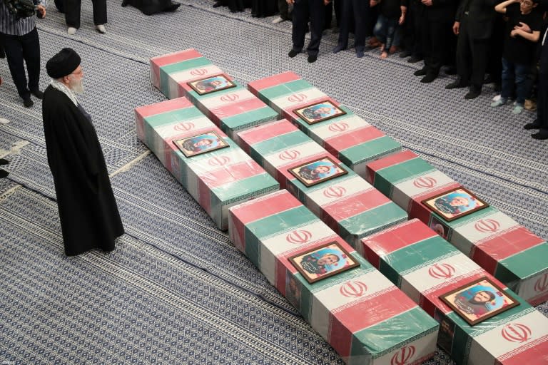 Iran's supreme leader Ayatollah Ali Khamenei leads prayers by the coffins of seven Revolutionary Guards killed in an April 1 air strike on the Iranian consulate in Damascus (-)