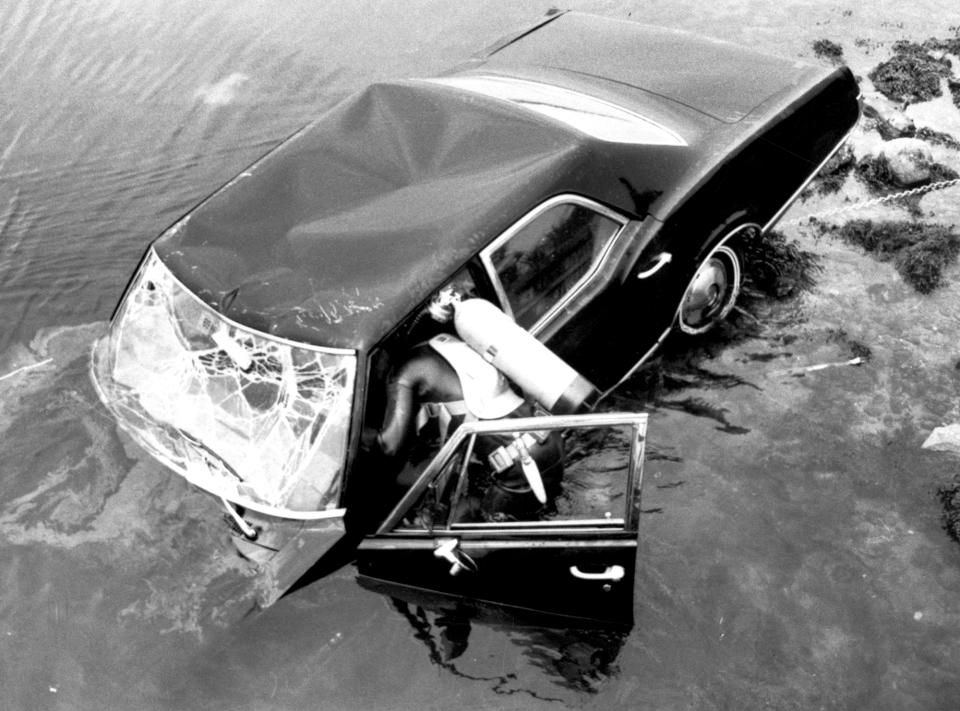 A frogman attempts to raise a car eight hours after it plunged into a pond with Sen. Edward Kennedy behind the wheel, on July 19, 1969, on Chappaquiddick Island, Mass. Mary Jo Kopechne was killed in the crash. Kennedy pleaded guilty to leaving the scene of an accident and received a suspended two-month jail sentence. (Photo: Bettmann/Getty Images)
