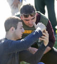 <p>A student shows a law enforcement officer a photo or video from his phone, Wednesday, Feb. 14, 2018, in Parkland, Fla. A shooting at Marjory Stoneman Douglas High School sent students rushing into the streets as SWAT team members swarmed in and locked down the building. Police were warning that the shooter was still at large even as ambulances converged on the scene and emergency workers appeared to be treating those possibly wounded. (Photo: Wilfredo Lee/AP) </p>