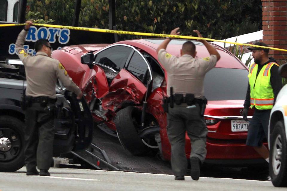 <p>Genaro Molina / Los Angeles Times via Getty</p> Sheriff deputies approach the scene where four women were killed in a multi-vehicle crash in Malibu on October 18, 2023.