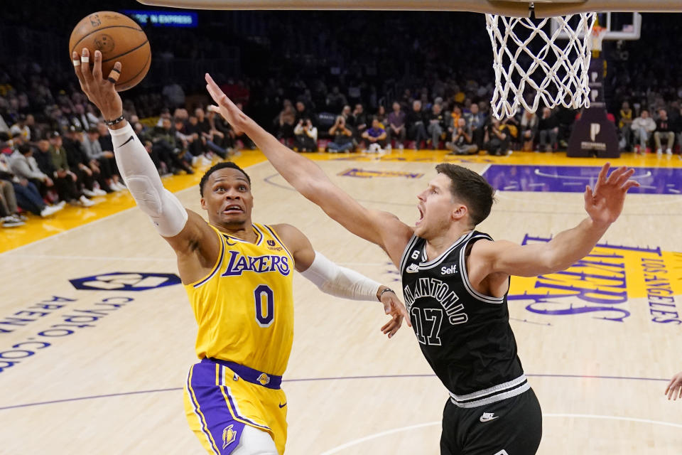 Los Angeles Lakers guard Russell Westbrook, left, shoots as San Antonio Spurs forward Doug McDermott defends during the second half of an NBA basketball game Wednesday, Jan. 25, 2023, in Los Angeles. (AP Photo/Mark J. Terrill)