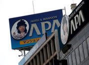 Signboards featuring pictures of APA hotel chain's president Fumiko Motoya is seen at its headquarters building in Tokyo, Japan, January 19, 2017. REUTERS/Kim Kyung-Hoon