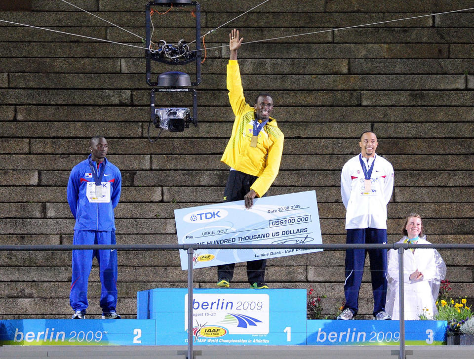 Usain Bolt jumps onto the platform tonight as he receives his Gold Medal for the 200m Event he won last night during the IAAF World Championships at the Olympiastadion, Berlin.