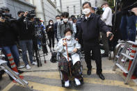 Former South Korean comfort woman Lee Yong-soo in a wheelchair leaves the Seoul Central District Court in Seoul, South Korea, Wednesday, April 21, 2021. A South Korean court on Wednesday rejected a claim by South Korean sexual slavery victims and their relatives who sought compensation from the Japanese government over their wartime sufferings. (AP Photo/Ahn Young-joon)