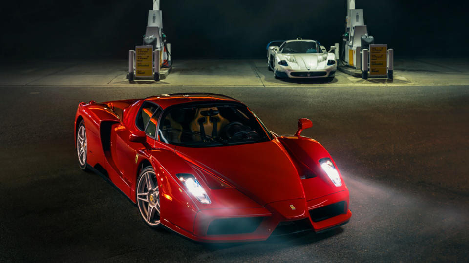 A 2004 Ferrari Enzo with a 2005 Maserati MC12 in the background.