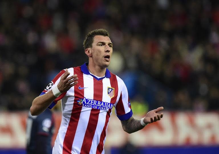 Atletico Madrid's Mario Mandzukic celebrates after scoring a goal during their UEFA Champions League Group A match against Olympiakos, at Estadio Vicente Calderon in Madrid, on November 26, 2014