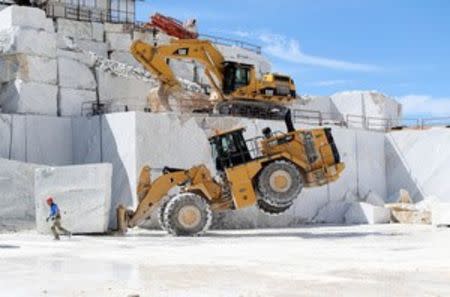 A bulldozer transports a marble stone at the Cervaiole quarry on Monte Altissimo in the Apuan Alps, Tuscany, Italy, July 15, 2017. REUTERS/Alessandro Bianchi