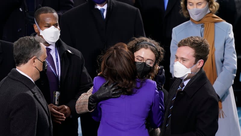 Vice President-elect Kamala Harris hugs her stepdaughter, Ella Emhoff, as she arrives for the 59th Presidential Inauguration at the U.S. Capitol in Washington, Wednesday, Jan. 20, 2021. Harris' stepson, Cole Emhoff, stands on the right.