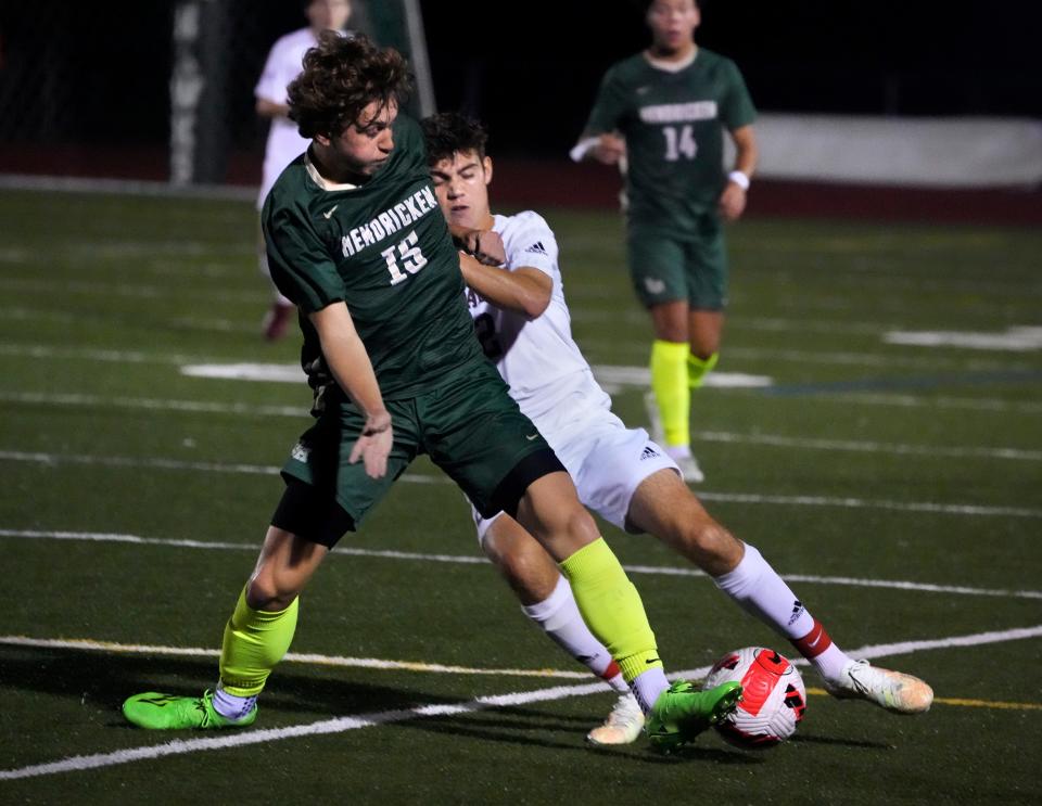 La Salle's Mac Jackson, center, battles Hendricken's Brennan Hill for the ball during a game last season. When not playing soccer, Jackson is the state's best boy golfer.