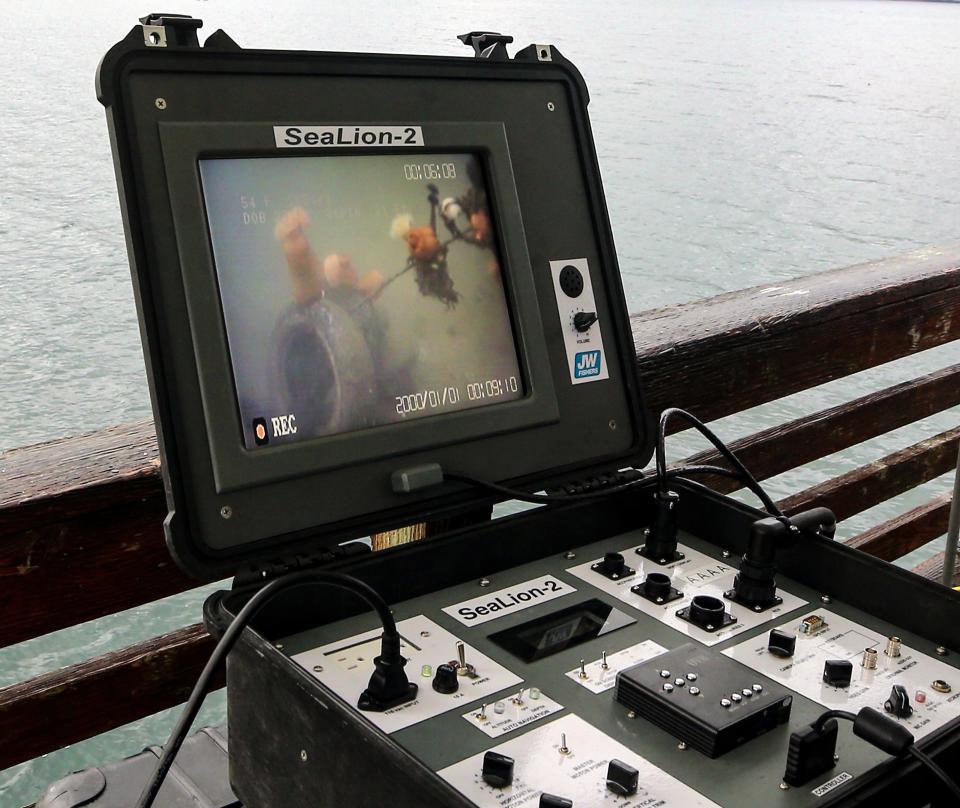 Sea anemones on a clump of tires are seen on the screen as Serco program manager Dustin Teuton pilots a SeaLion-2 remote operated vehicle off of the Port of Illahee Pier on Wednesday, Oct. 25, 2023.