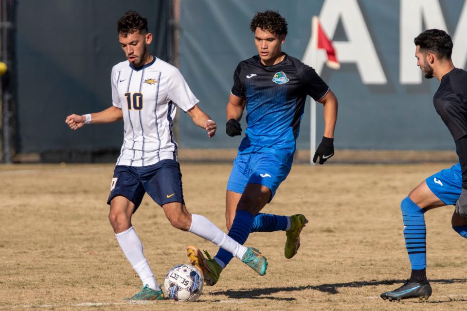 Oxnard College defender Emmanuel Solis, right, challenges Merced's Felipe Lopez in the CCCAA state semifinals at American River College in Sacramento on Friday. Oxnard won, 1-0.