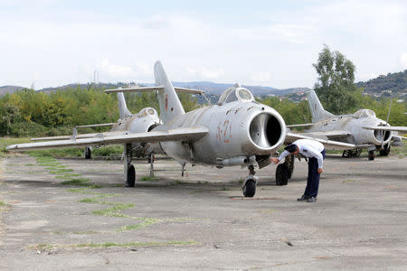 An Albanian Air Force crew member inspects a MiG-17 jet fighter in Kucova Air Base in Kucova, Albania, October 3, 2018. REUTERS/Florion Goga