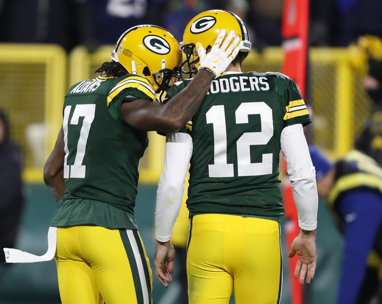 Green Bay Packers' Davante Adams celebrates his touchdown catch with Aaron Rodgers during the second half of an NFL football game against the Miami Dolphins Sunday, Nov. 11, 2018, in Green Bay, Wis. (AP Photo/Matt Ludtke)