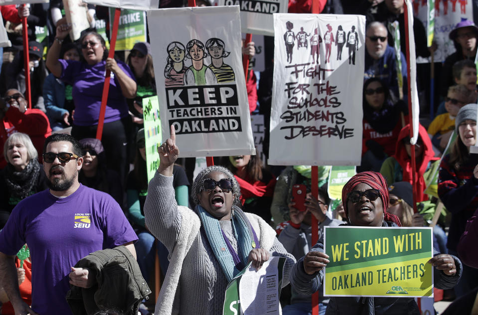 Teachers, students and supporters rally at Frank Ogawa Plaza in front of City Hall in Oakland, Calif., Thursday, Feb. 21, 2019. Teachers in Oakland, California, went on strike Thursday in the country's latest walkout by educators over classroom conditions and pay. (AP Photo/Jeff Chiu)