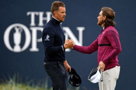 Jul 20, 2018; Carnoustie, SCT; Henrik Stenson and Tommy Fleetwood shake hands on the 18th green during the second round of The Open Championship golf tournament at Carnoustie Golf Links. Mandatory Credit: Thomas J. Russo-USA TODAY Sports