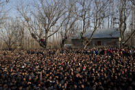 Kashmiri villagers watch the joint funeral of a civilian Abid Lone and local rebel Adnan Ahmed in Pulwama, south of Srinagar, Indian controlled Kashmir, Saturday, Dec. 15, 2018. At least seven civilians were killed and nearly two dozens injured when government forces fired at anti-India protesters in disputed Kashmir following a gunbattle that left three rebels and a soldier dead on Saturday, police and residents said. (AP Photo/ Dar Yasin)
