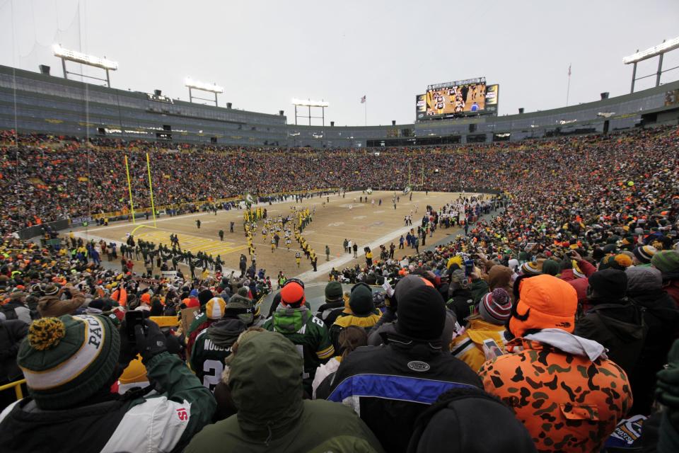 Green Bay Packers players are introduced to the field before an NFL wild-card playoff football game against the San Francisco 49ers, Sunday, Jan. 5, 2014, in Green Bay, Wis. (AP Photo/Kiichiro Sato)