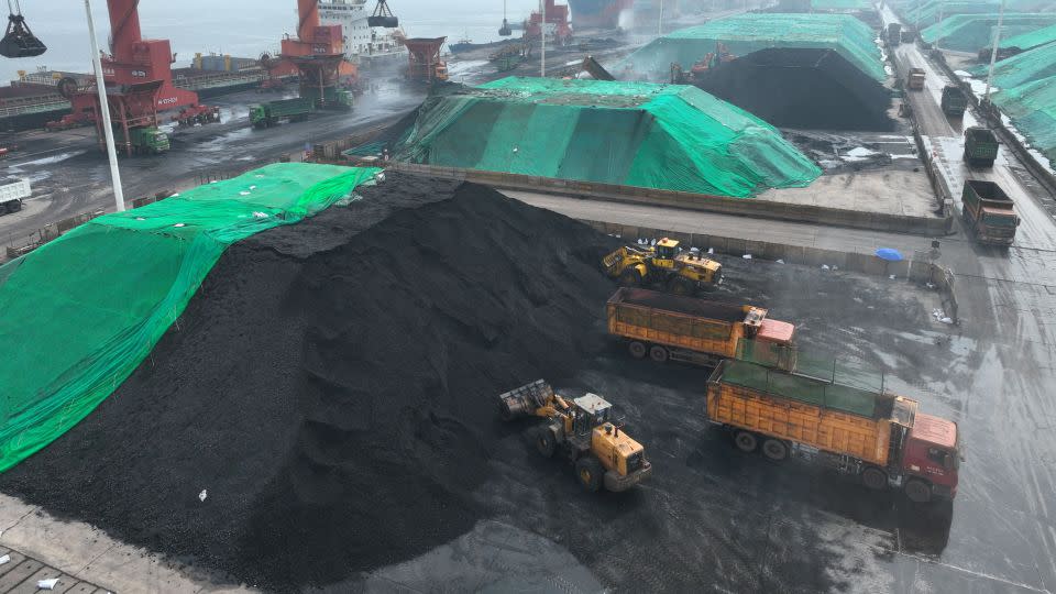 Coal is loaded onto trucks for delivery to power generation plants, after being unloaded from ships at the port in Lianyungang, in China's eastern Jiangsu province on July 12, 2023. - Stringer/AFP/Getty Images