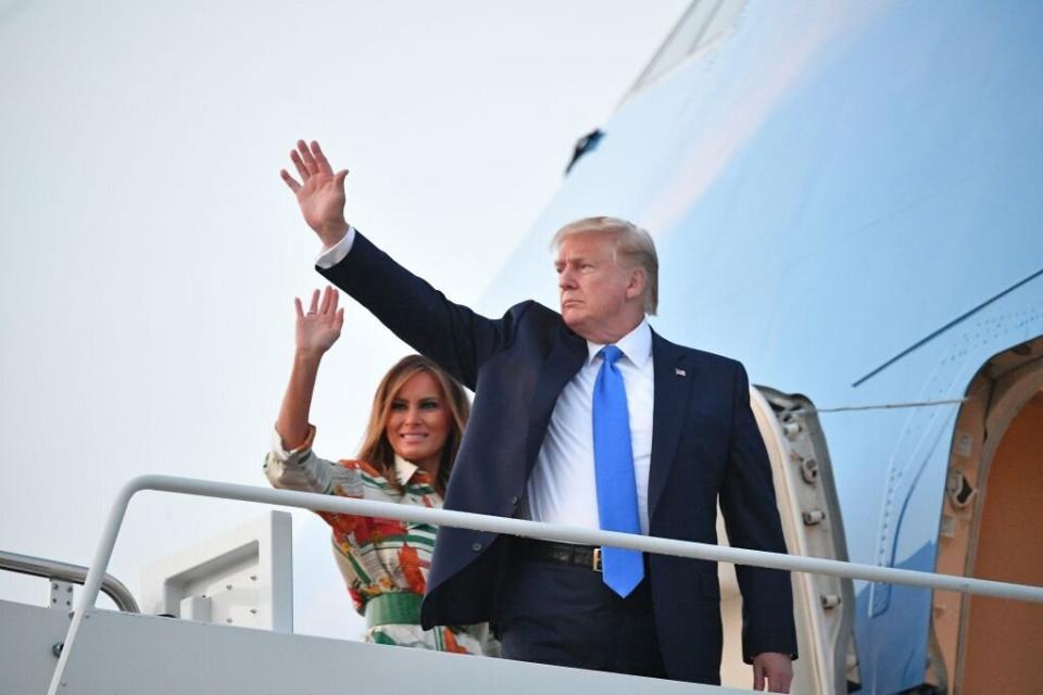 Melania Trump waves as she boards the plane to the UK with Donald. [Photo: Getty]