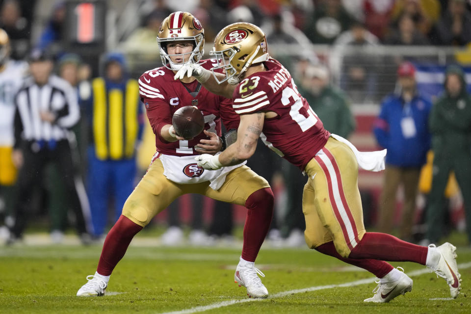 San Francisco 49ers quarterback Brock Purdy (13) hands off the ball to running back Christian McCaffrey (23) during an NFL football game against the Green Bay Packers Sunday, Jan. 21, 2024, in Inglewood, Calif. (AP Photo/Ashley Landis)