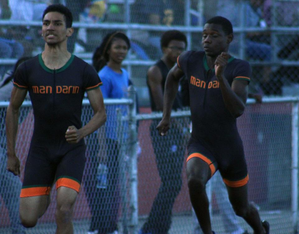 Mandarin's Stephen Degregorio (left) and Jaylen Lewis race in the boys 100 in the Gateway Conference track meet.