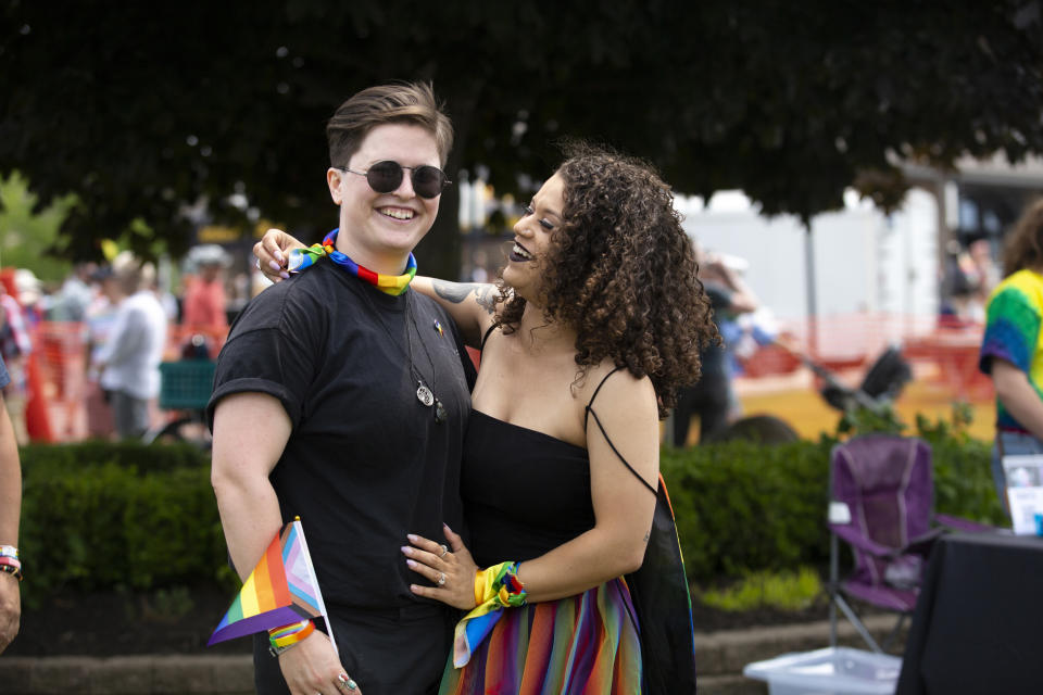 Sarina Bee, right, and wife, Mack pose for a portrait during Grand Haven Pride Fest in Grand Haven, Mich., on Saturday, June 10, 2023. The festival — which organizers had hoped would attract at least 500 attendees — drew thousands of people from all over who came to experience the first-time event's drag show, dance party and vendor-filled streets. (AP Photo/Kristen Norman)