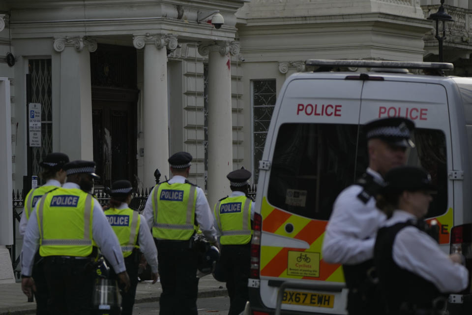 Police stand guard outside the Iranian Embassy after a small group protesters threw paint at the building in London, Sunday, Sept. 25, 2022. They were protesting against the death of Iranian Mahsa Amini, a 22-year-old woman, who died in Iran while in police custody, was arrested by Iran's morality police for allegedly violating its strictly-enforced dress code. (AP Photo/Alastair Grant)