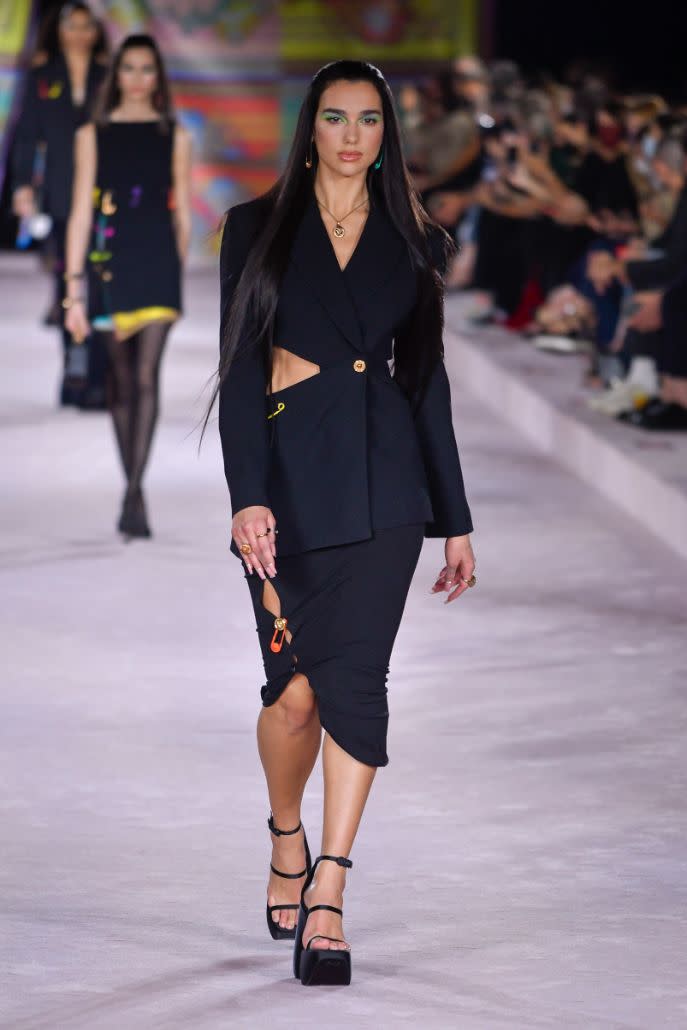 Dua Lipa walks the runway for Versace spring ’22 show. - Credit: Moda Milano/IPA/Splash News