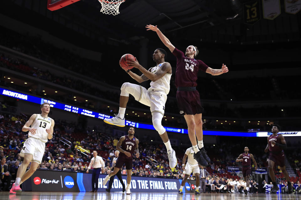 <p>Charles Matthews #1 of the Michigan Wolverines attempts a shot past Bobby Moorehead #24 of the Montana Grizzlies in the second half during the first round of the 2019 NCAA Men’s Basketball Tournament at Wells Fargo Arena on March 21, 2019 in Des Moines, Iowa. </p>