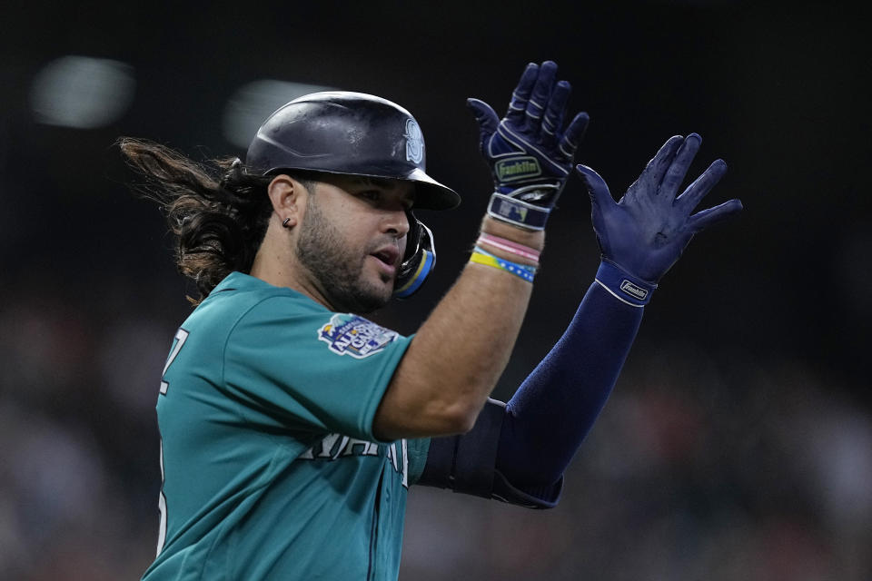 Seattle Mariners' Eugenio Suarez celebrates after hitting a two run home run during the second inning of a baseball game against the Houston Astros, Sunday, Aug. 20, 2023, in Houston. (AP Photo/Kevin M. Cox)