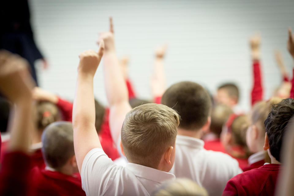 unidentifiable children in a primary school assembly