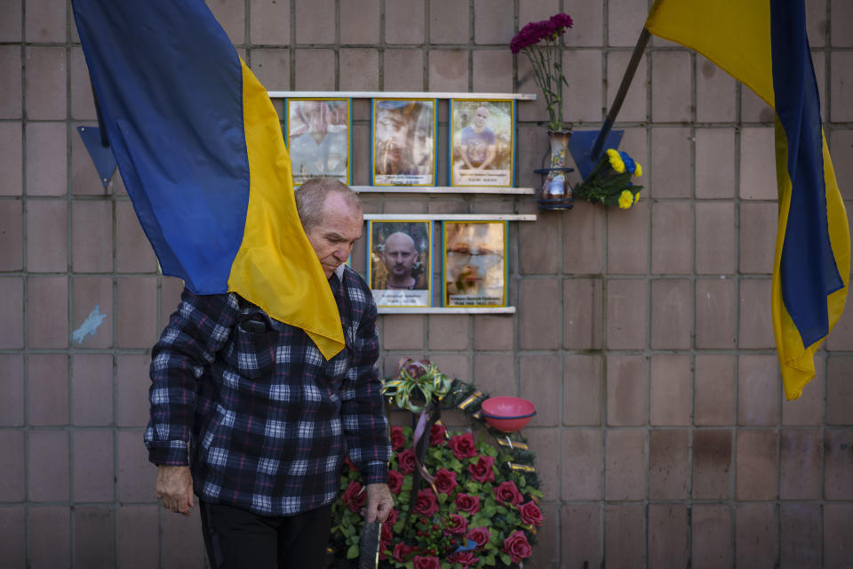 Oleksandr Turovskyi, father of Sviatoslav Turovskyi, in the top right picture, one of the men killed by Russian forces near the building on Yablunska street, leaves after bringing fresh flowers to the place where his son's body was abandoned, in Bucha, Ukraine, Tuesday, March 26, 2024. Days after Russian forces withdrew from the area in late March, in the dramatic first weeks of the full-scale invasion, a photo taken by AP Photographer Vadim Ghirda revealed what happened to the eight men. (AP Photo/Vadim Ghirda)