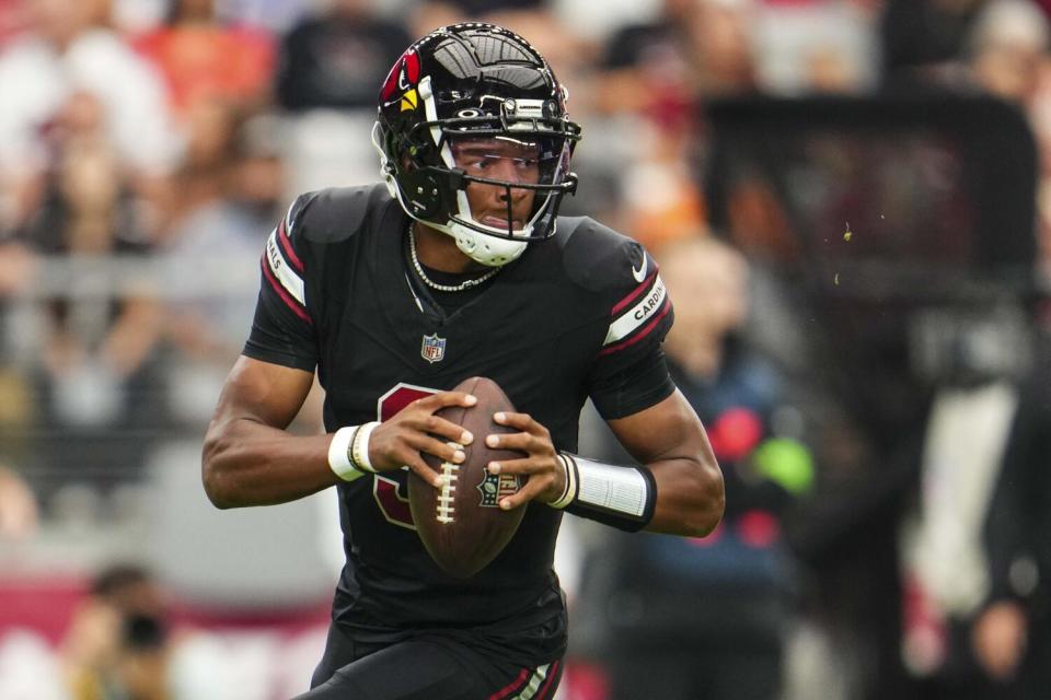 Cardinals quarterback Joshua Dobbs readies to pass.