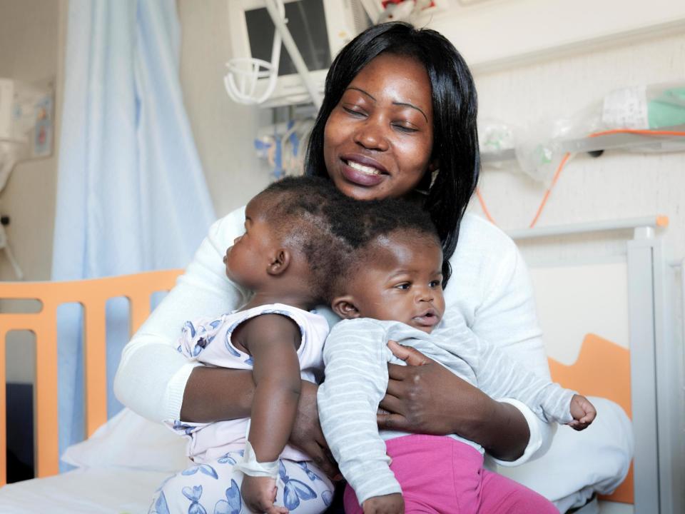 Twin sisters Ervina and Prefina, who had been joined from the back of the head since birth, are pictured with their mother Ermine before going into surgery: Ospedale Pediatrico Bambino Gesu/Handout via REUTERS