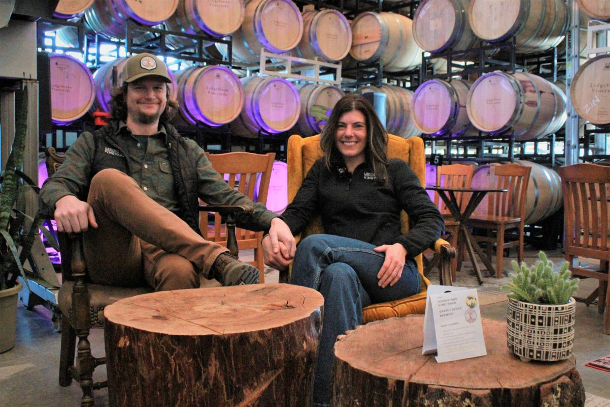 Owners Adam and Katrina Magnuson sit in the cellar of LedgeStone Vineyards, 6381 State 57, in Greenleaf. The two recently expanded the winery's offerings to include a full-service kitchen.