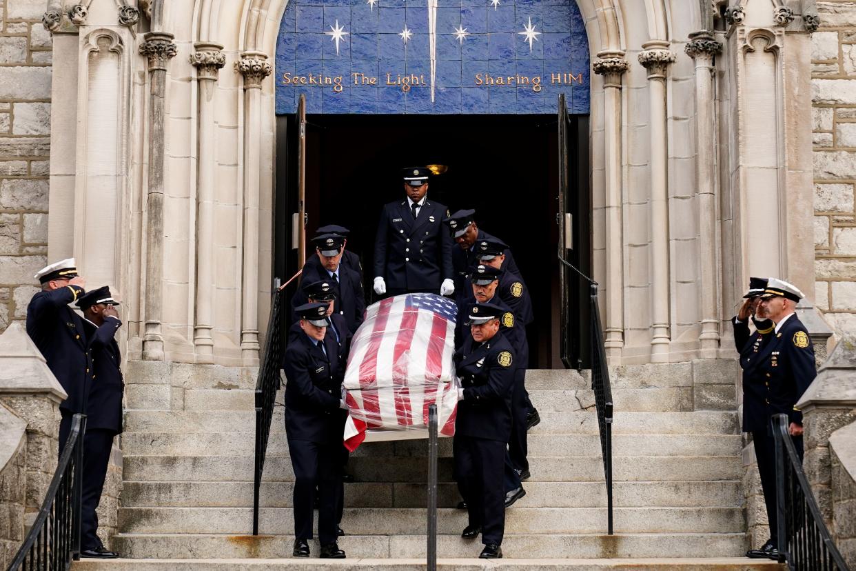 The remains of Lt. Sean Williamson, a 27-year veteran of the Philadelphia Fire Department, are brought from Epiphany of Our Lord Catholic Church ahead of a procession and funeral mass in Philadelphia Monday.