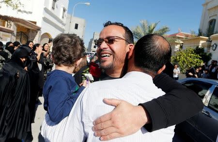 Ali Al-Ekri (C) hugs his family member (R) as he is welcomed home after completing his five-year sentence, in Manama, Bahrain March 10, 2017. REUTERS/Hamad I Mohammed